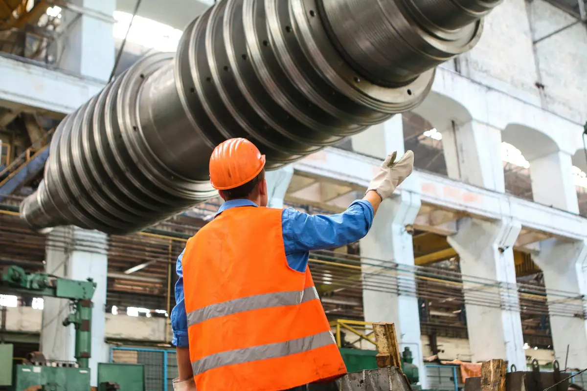 Manufacturing consultant analyzing production workflow on a CNC shop floor with value stream map