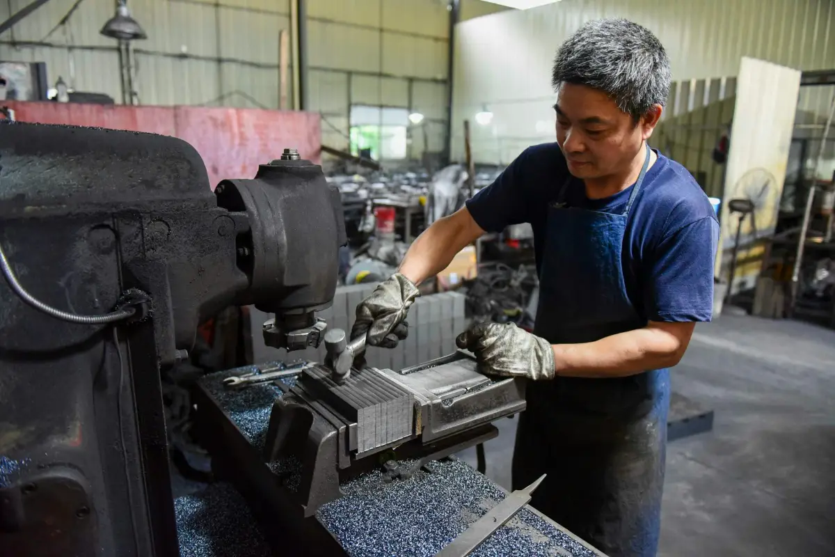 Manufacturing consultant conducting a detailed time study during a CNC machine changeover